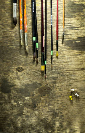 Set of art brushes on a wooden background