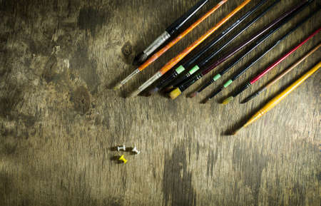 Set of art brushes on a wooden background
