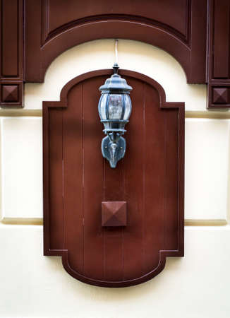 The old street lamp on the stone wall backgroundの写真素材