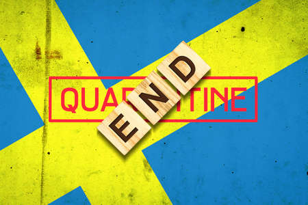 End of quarantine. The inscription on wooden blocks on the background of the flag of Sweden. The end of the pandemic. Business. Travels.の写真素材
