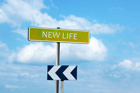 New life. Road sign against a blue cloudy sky. The beginning of a new life. New Career.Success.の写真素材