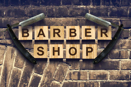 Concept Barber Shop. An inscription on wooden cubes against the background of an old vintage wall. Beauty. Fashionの写真素材