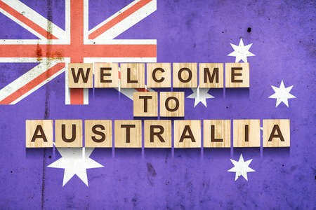 Welcome to Australia. The inscription on wooden blocks on the background of the flag of Australia. Travels.の写真素材