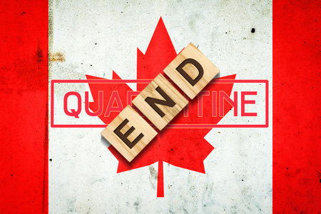 End of quarantine. The inscription on wooden blocks on the background of the flag of Canada. The end of the pandemic. Business. Travels.の写真素材