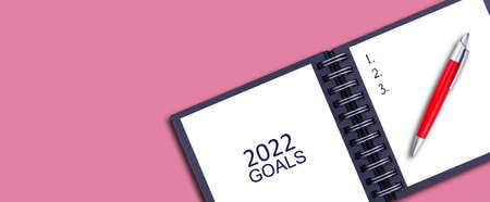 2022 Goals. Notepad and pen on the pink background. Concept of goals for the New Year. Copy space. Place for your text. Business. Lifestyle. Background.の写真素材