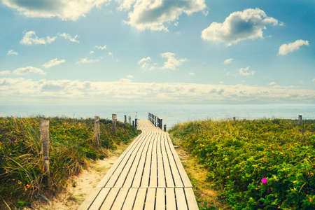 Wooden bridge to the sea. The sky with beautiful clouds. Recreation.Travel. Summer.の写真素材