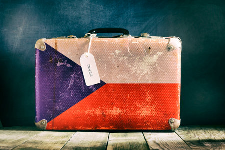 Old suitcase with Czech Republic flag on wooden background. Travels.の写真素材