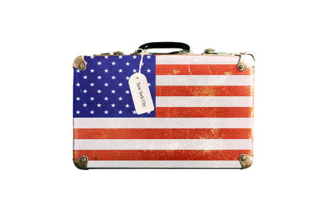 Old suitcase with the flag of America. Isolated on a white background.の写真素材