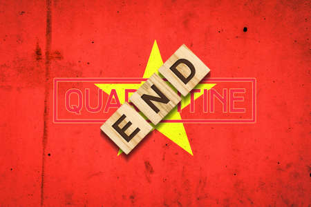End of quarantine. The inscription on wooden blocks on the background of the flag of Vietnam. The end of the pandemic. Business. Travels.の写真素材