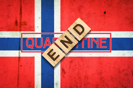 End of quarantine. The inscription on wooden blocks on the background of the flag of Norway. The end of the pandemic. Business. Travels.の写真素材