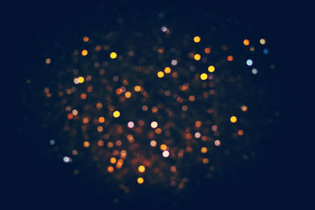 Multi-colored lens flare on dark blue background. No focus. Abstract background