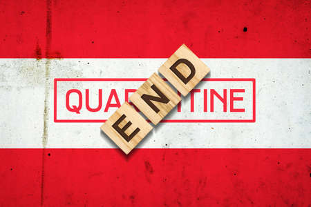 End of quarantine. The inscription on wooden blocks on the background of the flag of Austria. The end of the pandemic. Business. Travelsの写真素材