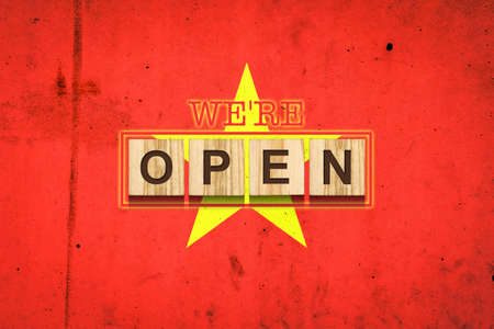 We are open. The inscription on wooden blocks against the background of the flag of Vietnam. Business. Travelの写真素材