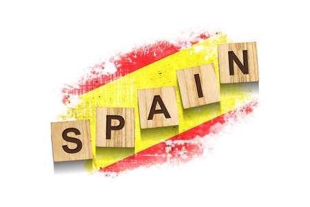 Spain. The inscription on wooden blocks, against the background of the flag of Spain. Isolated on a...