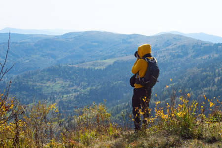 Photographer photographing a mountain landscape. Hobby, vacation Travelsの写真素材