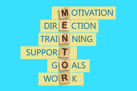 Concept Mentor. Words written on a wooden block. Blue background. Business. Leadership concept.