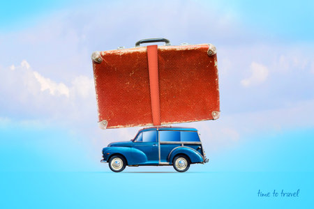 Blue old cars with a suitcase on the trunk. On a blue background. Travel concept. Summer holiday.の写真素材