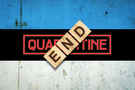 End of quarantine. The inscription on wooden blocks on the background of the flag of Estonia. The end of the pandemic. Business. Travelsの写真素材