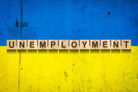 Unemployment. The inscription on wooden blocks on the background of the Ukraine flag. Unemployment growth. Business. Job.の写真素材