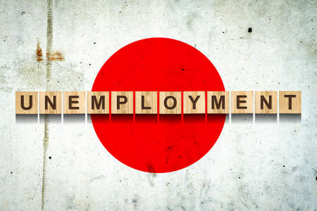Unemployment. The inscription on wooden blocks on the background of the Japan flag. Unemployment...