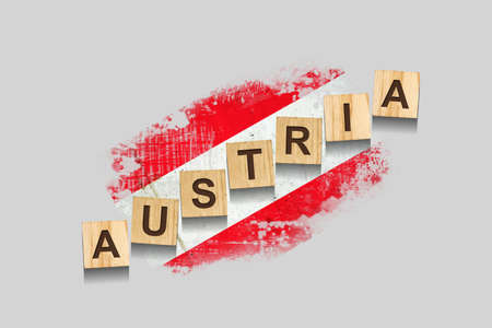 Austria. The inscription on wooden blocks, against the background of the flag of Austria. 3D illustration. Isolated on a gray background. Design elementの写真素材