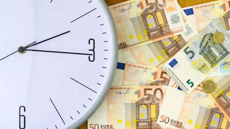 Clock and banknotes of Euro. Concept time is money. View from above. Business, finance. Background.の写真素材