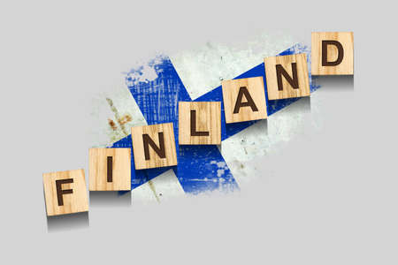 Finland. The inscription on wooden blocks, against the background of the flag of Finland. 3D illustration. Isolated on a gray background. Design elementの写真素材