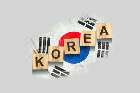 Korea. The inscription on wooden blocks, against the background of the flag of Korea. 3D illustration. Isolated on a gray background. Design elementの写真素材