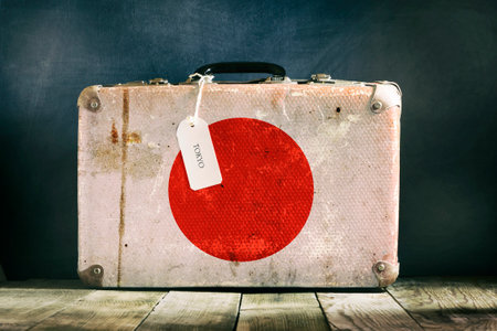 Old suitcase with the Japan flag on wooden background. Travelsの写真素材