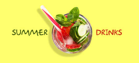 Cocktail with cucumber, strawberry, mint, and ice on a green background.Top view. Copy space. Place for text. Summer drinks. Summer rest.の写真素材