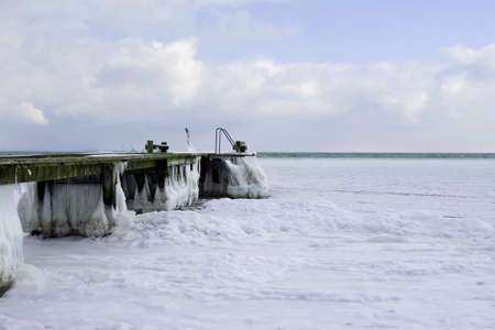 Frozen pier on the sea. Denmark. Baltic Sea. Natural phenomena. Seascapeの写真素材