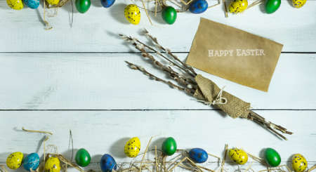 Easter colorful eggs on white wooden background. Top view with copy spaceの写真素材