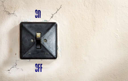 Old electric wall-mounted light switch with falling shade