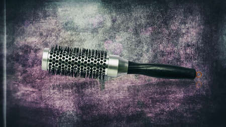 Barber comb for styling hair ,, on a dark, shabby grunge background. Copy space. Beauty and fashion.