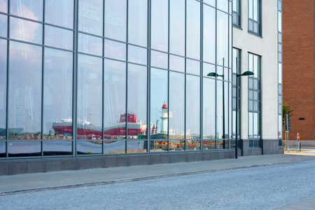 Malmo, Sweden. July 29, 2019, Beautiful, modern, glass building, in which the reflection of the ship in the port .. Malmo Architectural landmarks of Sweden. Architecture.のeditorial素材