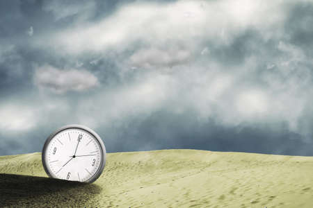 Clock in the sand dunes. Cloudy sky. Time concept. Business. Lifestyle. Abstraction background.の写真素材