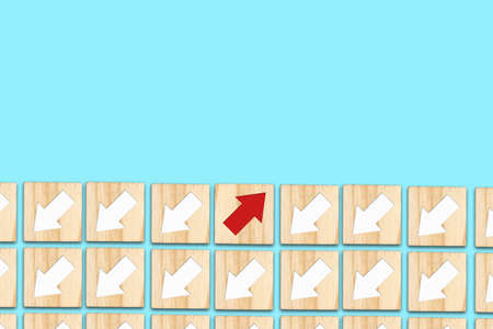 Wooden blocks with white and red arrows. Different directions. Leadership success concept. Innovative solution. Individual concept. Right choice. Career growth. Business.の写真素材