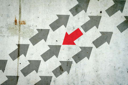 Arrows on a concrete wall. Red arrow, right direction. Leadership concept. Team. Business Financeの写真素材