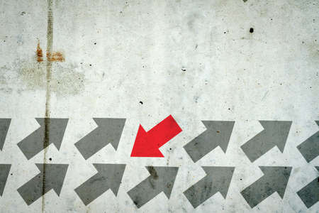 Arrows on a concrete wall. Red arrow, right direction. Leadership concept. Team. Business Financeの写真素材