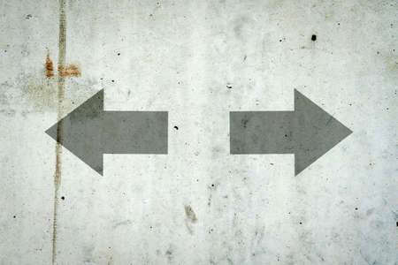Arrows in different directions on a concrete wall. Choice concept. Copy space. Business. Finance.の写真素材
