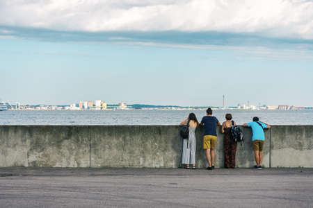 Group of people admiring the beautiful sea view from the embankment. Helsingor. Denmark. Relaxation. Travels.の写真素材