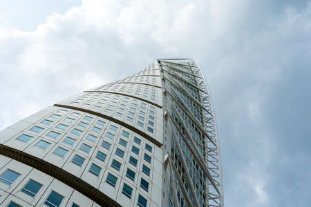 Malmo. Sweden. July 29.2019. Turning Torso, a beautiful skyscraper against a cloudy sky. Bottom view. Architecture Attractionsのeditorial素材