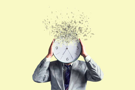 Businessman with a disintegrating clock instead of a head. dispersion effect. Lack of time. Waste of time. business. lifestyle. backgroundの写真素材