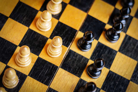White and black pawns on a chessboard. selective focus. top view. strategy. sport. business. background.の写真素材