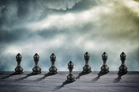 Pawn is ahead of the others. cloudy sky. leadership concept. success. abstraction. business backgroundの写真素材