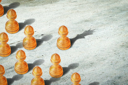 Pawn with the shadow of the queen, in front of the pawns. leadership concept. strength and inspiration. Confidence in your strength. business. lifestyle. abstract background. background.の写真素材