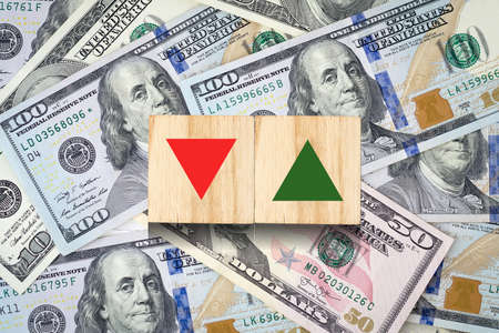 Direction selection concept. Red and green arrows pointing in different directions against the background of dollar bills. business. finance. background.の写真素材