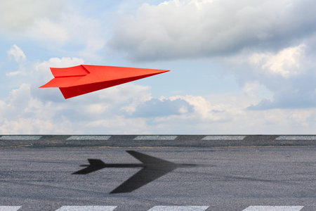 Paper plane casting the shadow of an airplane. Travel concept, business idea, leadership, success, teamwork, creative idea, vision. business. lifestyle backgroundの写真素材