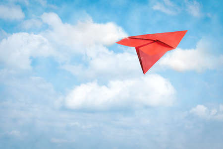 Paper plane flies in the cloudy sky. Travel concept, business success. copyspace. Travel, business, background.の写真素材
