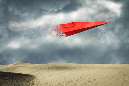 Paper airplane in the cloudy sky, over the sand dunes. Travel concept, business success. copyspace. Travel, business, background.の写真素材